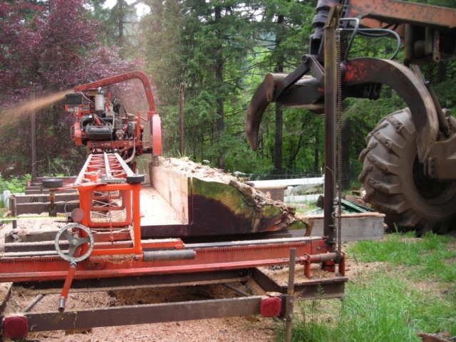 Cutting a 2-1/2 inch slab from the center of a redwood log while producing dimensional lumber